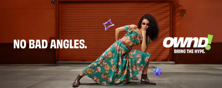 A vibrant fashion advertisement for the brand OWND! featuring a young woman in a teal floral crop top and high-waisted skirt posing against an orange industrial backdrop with the tagline "NO BAD ANGLES" and "BRING THE HYPE."