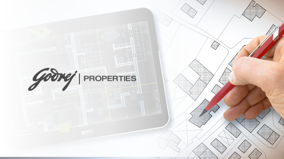 Why Godrej Properties’ Thane JDA is Mumbai’s Best Real Estate Investment for 2026 1 A digital tablet displaying a detailed architectural floor plan with the Godrej Properties logo, positioned next to a physical site map being marked with a red pen.