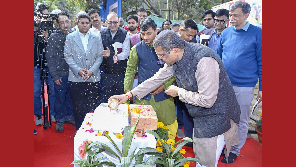 Union Education Minister Dharmendra Pradhan performing a traditional foundation-laying ceremony at IIT Delhi, breaking a coconut on a ceremonial brick for the new Academic Block and Girls' Hostel.