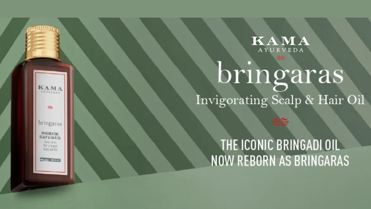 A bottle of Kama Ayurveda Bringaras Invigorating Scalp and Hair Oil showcased against a green striped background, highlighting the rebranding from the iconic Bringadi Oil.