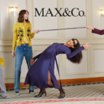 Four models in a high-status interior setting showcasing contemporary Italian fashion from MAX&Co., featuring a mix of tailoring, denim, and vibrant colors under the brand's logo.