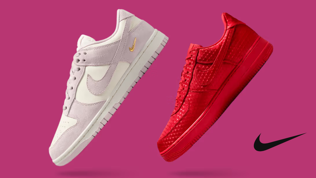 A high-contrast studio shot of two Nike sneakers from the 2026 Valentine's collection; one is a soft pink suede Dunk Low with a gold Swoosh, and the other is an all-over heart-embroidered Air Force 1 in vibrant University Red, set against a deep magenta background.