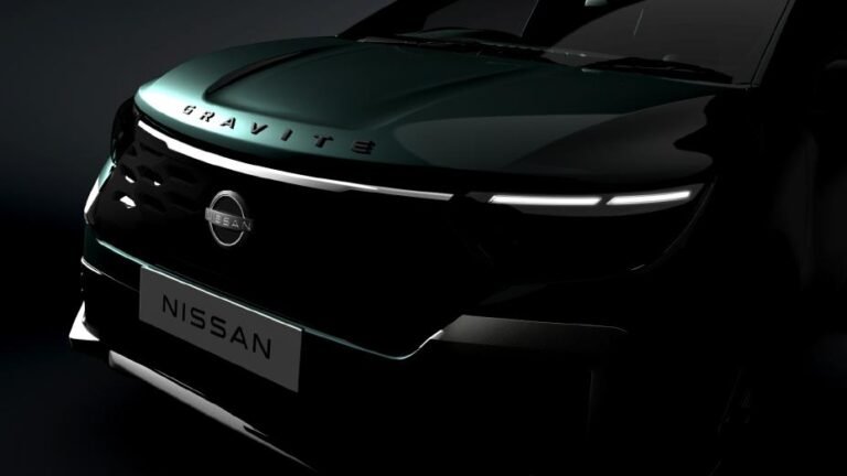 A close-up teaser of the Nissan Gravite's front end showing the illuminated V-Motion grille and "GRAVITE" hood branding.