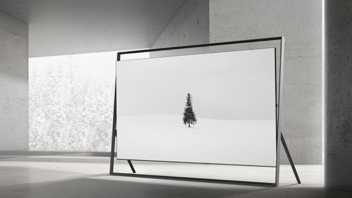 Samsung 130-inch Micro RGB display featuring the Vision AI Companion (VAC) in a minimalist "Timeless Frame" floor stand, showcasing a black and white winter landscape in a modern concrete room.