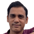 Headshot of Ashfaque, an udhq social strategist with dark hair and a maroon shirt, smiling against a plain white background.
