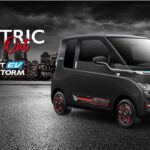 A side-profile view of the MG Comet EV Blackstorm Edition in Starry Black paint with red accents on the wheels and side body, set against a dark city skyline background.