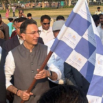 An official flagging off the Kaushal Rath mobile AI bus in Delhi to launch the Yuva AI for All literacy program.