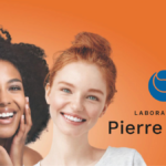 Two smiling women of diverse ethnicities posing against an orange background next to the Laboratoires Pierre Fabre logo.