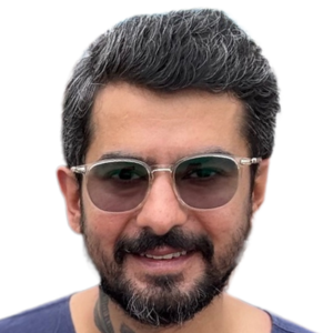 About Us 1 Close-up headshot of Sumit, Lead Curator with clear-framed glasses and a beard.