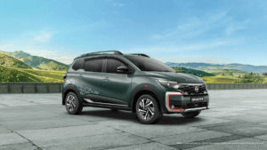 Side profile of the new Nissan Gravite Launch Edition in Forest Green featuring signature orange bumper accents and tire-t...