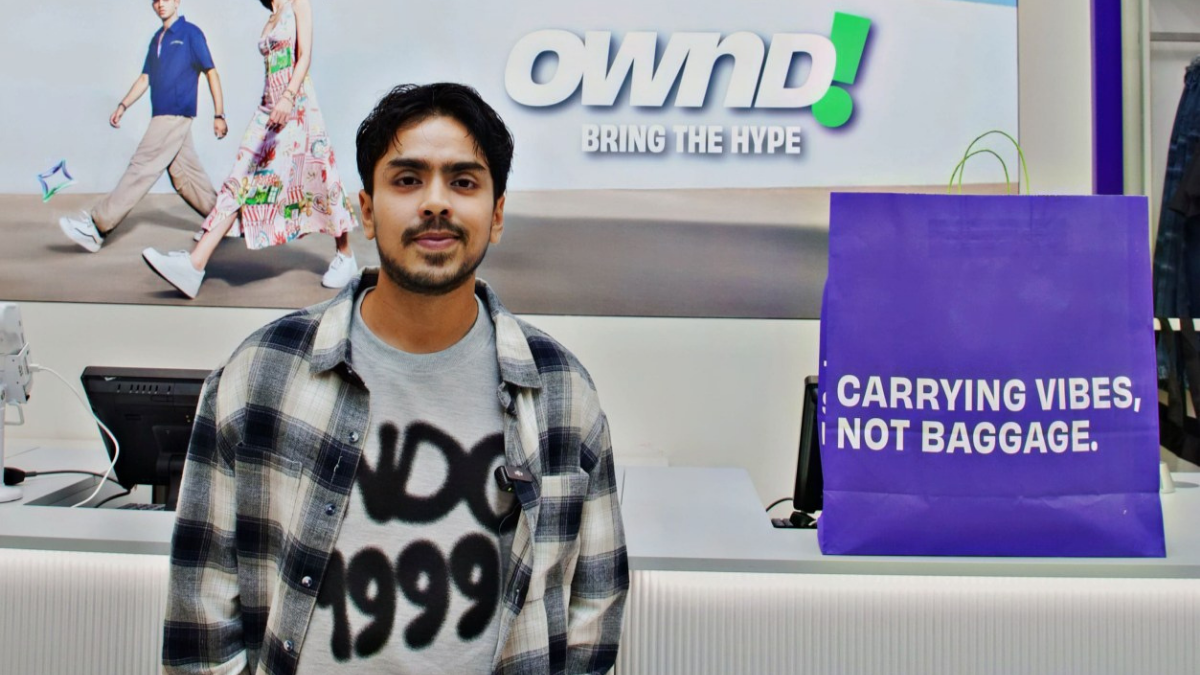 Actor Adarsh Gourav wearing an OWND! graphic tee and flannel shirt at the Mumbai store launch.