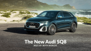 Front-three-quarter view of the new Audi SQ8 in a dark metallic shade parked on a coastal road, showcasing the V8 performa...