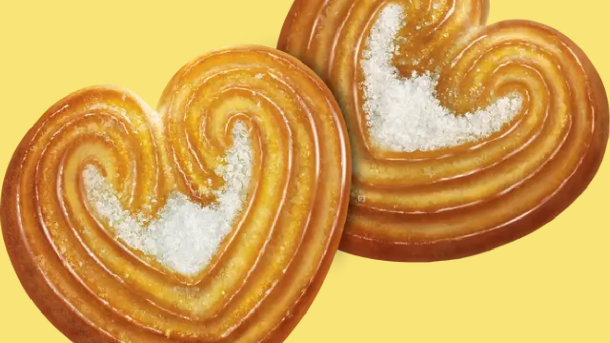 Britannia’s 2026 Launch Blitz: From Aamir Khan’s NutriChoice to the Viral 50-50 Cheeze Dipped 3 Close up of two heart-shaped, sugar-glazed Britannia Little Hearts biscuits on a yellow background.
