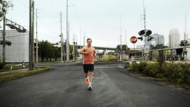 adidas Supernova Rise 3 Adaptive: A New Era of Inclusive Performance Running 1 Ironman athlete Chris Nikic running on a city street wearing the orange adidas Supernova Rise 3 Adaptive performance shoes.
