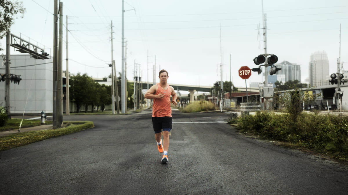 adidas Supernova Rise 3 Adaptive: A New Era of Inclusive Performance Running 1 Ironman athlete Chris Nikic running on a city street wearing the orange adidas Supernova Rise 3 Adaptive performance shoes.