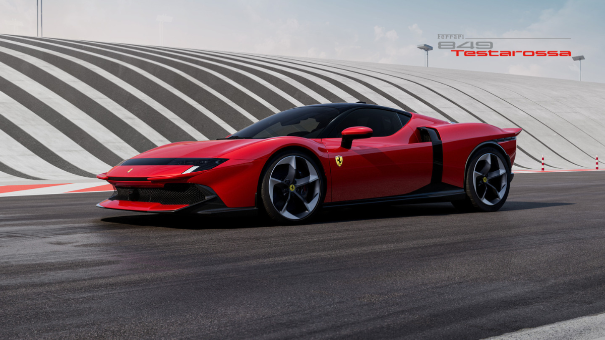 The Legend Reborn: Ferrari 849 Testarossa Officially Debuts in India 2 A futuristic red Ferrari 849 Testarossa concept car with a black roof and aerodynamic body, parked on a racetrack with a striped banked curve background.