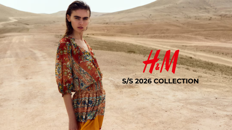 A fashion model wearing a colorful patterned bohemian-style dress from the H&M Spring/Summer 2026 collection in a desert landscape setting.