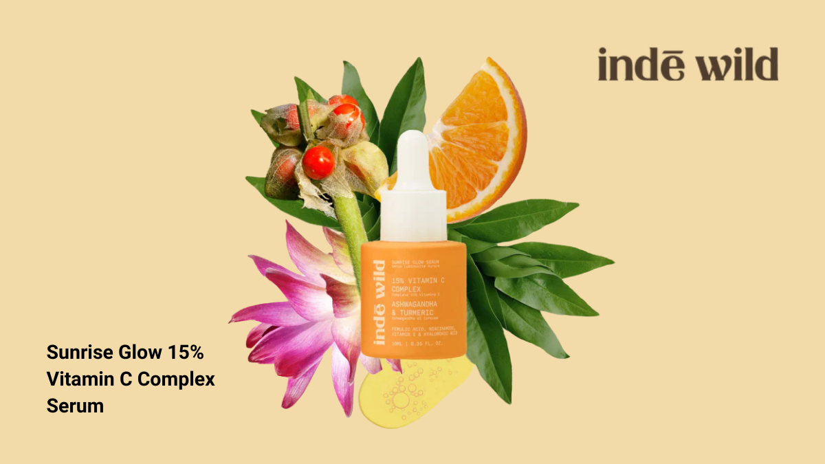indē wild Sunrise Glow 15% Vitamin C Complex Serum bottle with orange, turmeric, and ashwagandha botanical elements.