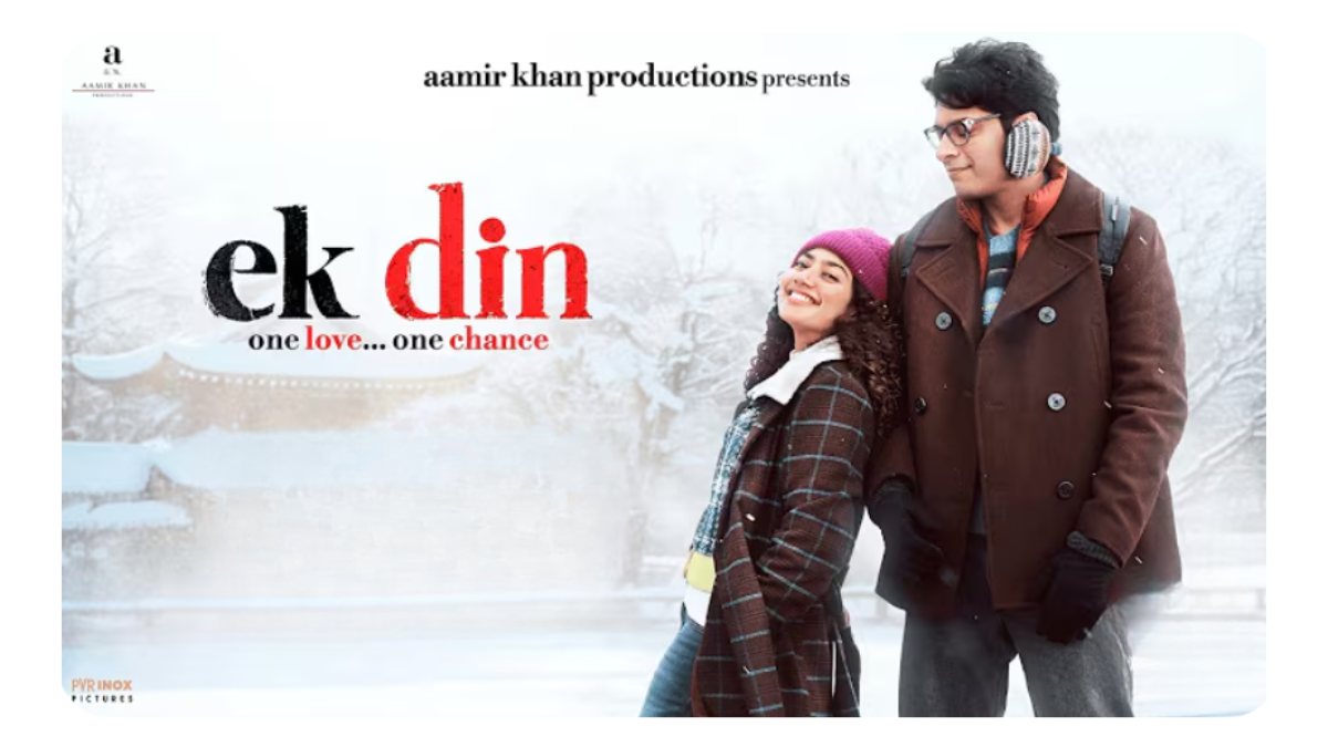 Junaid Khan and Sai Pallavi standing in a snowy landscape in Japan for the official poster of the movie Ek Din by Aamir Khan Productions.
