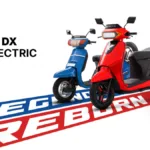 A side-by-side comparison of the classic blue Kinetic Honda and the new red Kinetic DX EV electric scooter on a 'Legend Re...