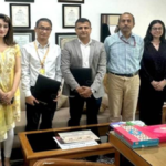 Officials from KRAFTON India and DPIIT posing together with signed Memorandum of Understanding documents at a formal ceremony.