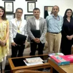 Officials from KRAFTON India and DPIIT posing together with signed Memorandum of Understanding documents at a formal ceremony.