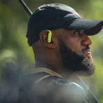 Side profile of LeBron James wearing the Nike x Powerbeats Pro 2 earbud in Volt colorway during the 'Keep Your Head in The Game' campaign.
