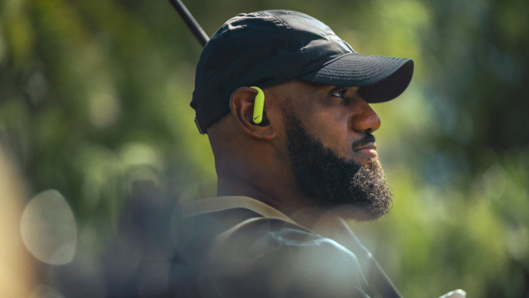 Side profile of LeBron James wearing the Nike x Powerbeats Pro 2 earbud in Volt colorway during the 'Keep Your Head in The Game' campaign.