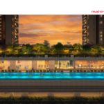 Luxury infinity pool and modern glass-walled clubhouse at Mahindra Rainforest, Kanjur, featuring lush rooftop greenery and residential towers at sunset.
