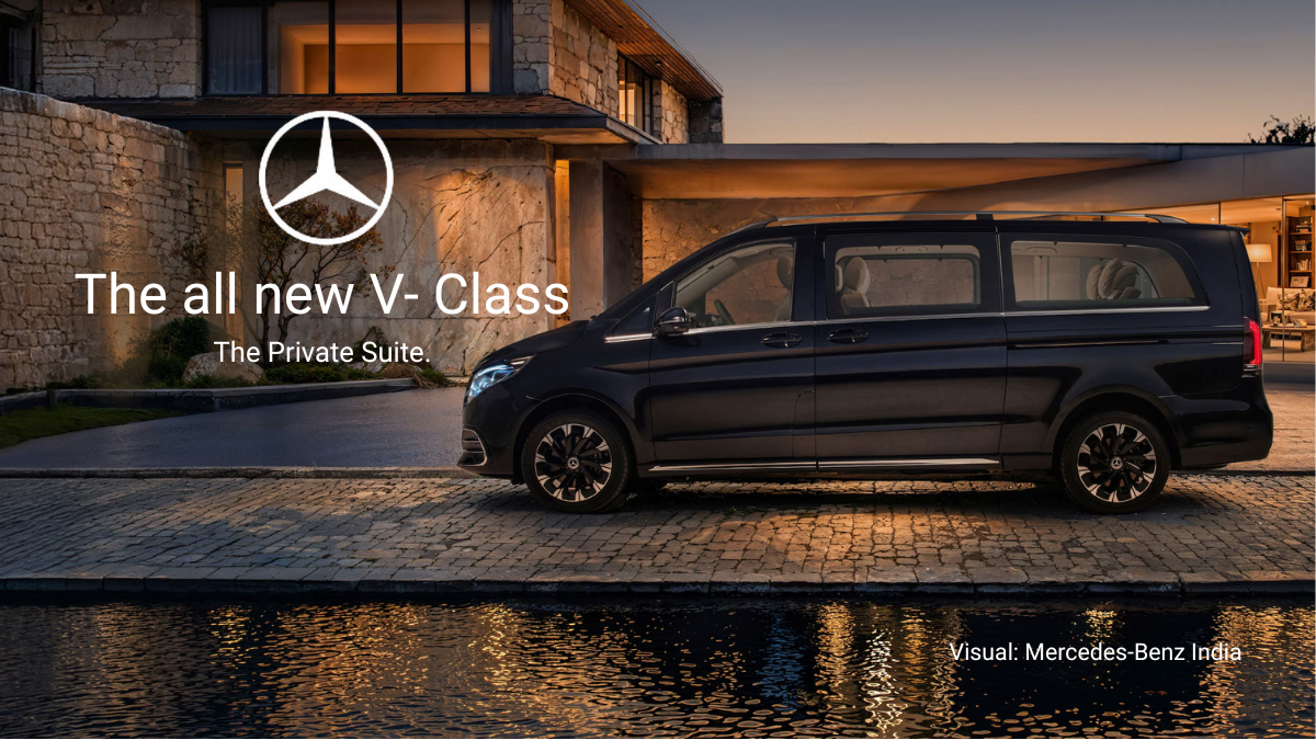Exterior shot of the Mercedes-Benz V-Class parked in front of a luxury villa at sunset.