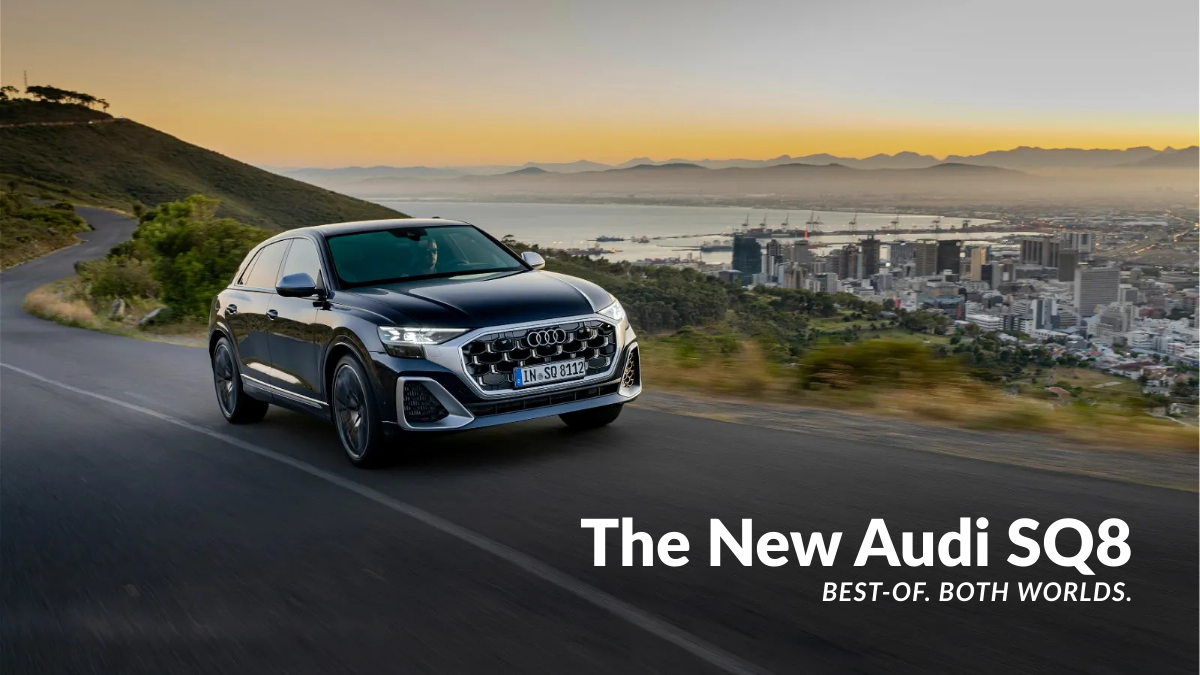 The new Audi SQ8 performance SUV driving on a winding hillside road at sunset with a city skyline in the background, emphasizing its "Best-of-both-worlds" tagline.