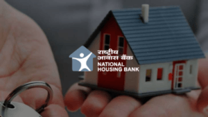 National Housing Bank (NHB) logo displayed over hands holding a small house model and keys, representing the digital Gruh ...