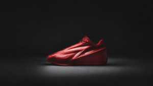 A side-profile studio shot of the all-red Nike KD19 basketball shoe highlighting the prominent TPU dagger lockdown system ...