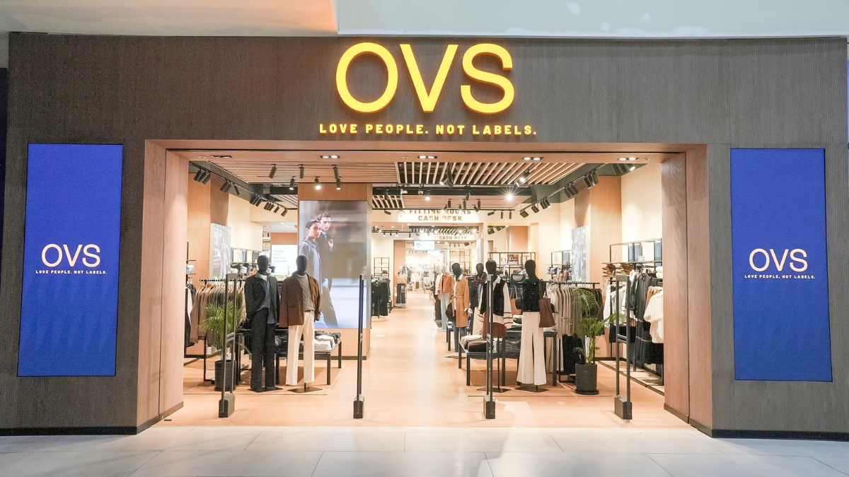 Exterior view of the OVS flagship store at Sky City Mall Borivali Mumbai, featuring a modern wood-paneled storefront with the slogan 'Love People Not Labels'.