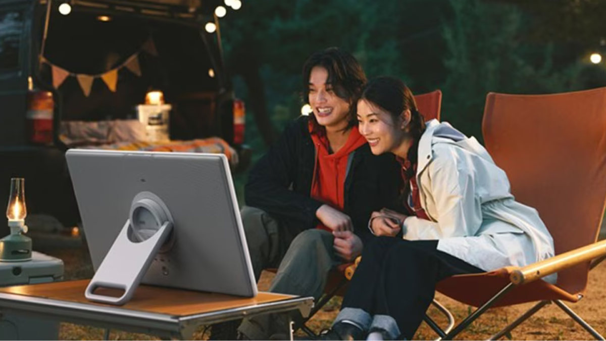 Samsung The Movingstyle: The Portable Screen on Wheels Is Finally Rolling Out. What India Needs to Know! 3 A couple watching a movie outdoors at night using the battery-powered Samsung Movingstyle screen on a camping table.