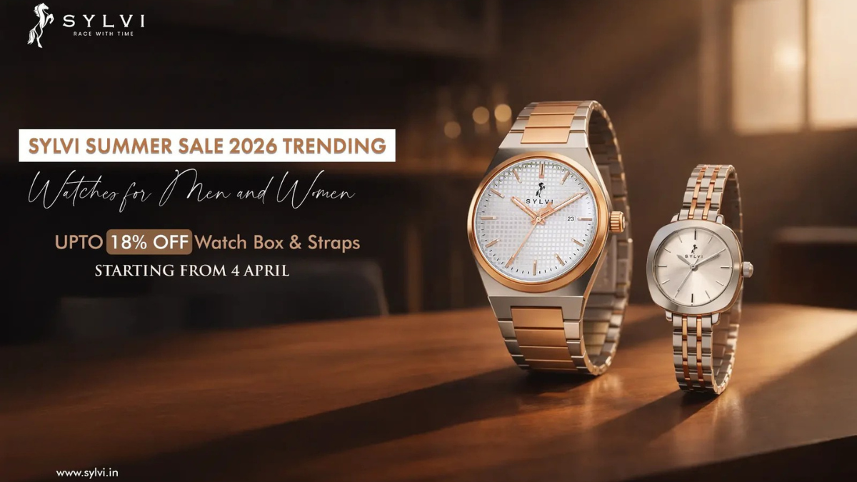 Sylvi Summer Sale 2026: Upgrade Your Wrist Game with Trending Watches for Men and Women (Up to 18% Off) 1 An advertisement poster for the Sylvi Summer Sale 2026. The text reads "SYLVI RACE WITH TIME" with a logo, and "SYLVI SUMMER SALE 2026 TRENDING Watches for Men and Women." Below it, "UPTO 18% OFF Watch Box & Straps STARTING FROM 4 APRIL". Two premium watches are featured on a wooden surface in warm light: a larger men's bicolor silver and rose gold watch with a white textured dial, and a smaller matching women's bicolor watch with a smooth silver dial. The website "www.sylvi.in" is at the bottom.