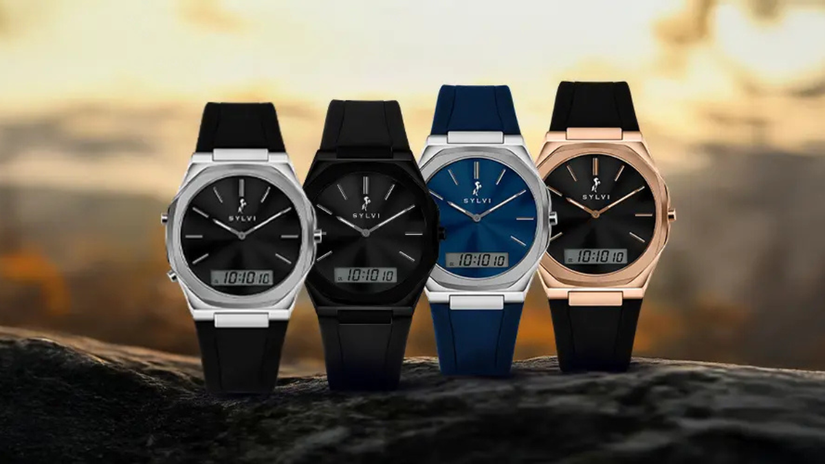 Four Sylvi TimeShift silicone strap hybrid watches for men in black, blue, and rose gold finishes against a sunset outdoor backdrop.