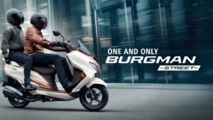 Side profile of the new 2026 Suzuki Burgman Street scooter in cream color with a rider and pillion in a modern city setting.