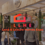 A busy exhibition booth at the Land & Leisure Homes Expo (LLHE) in Mumbai, featuring rustic wooden decor, hanging greenery...