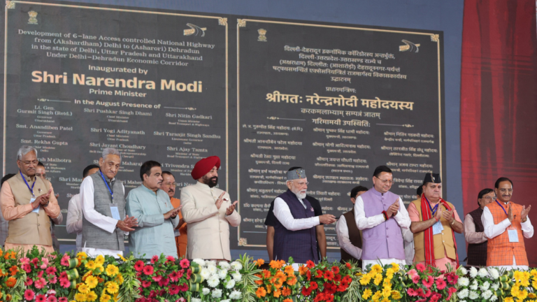 Prime Minister Narendra Modi on stage with Nitin Gadkari and Pushkar Singh Dhami inaugurating the 6-lane Delhi-Dehradun Ec...