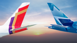 Air India and WestJet airplane tail fins facing each other against a sunset sky for their India-Canada partnership.
