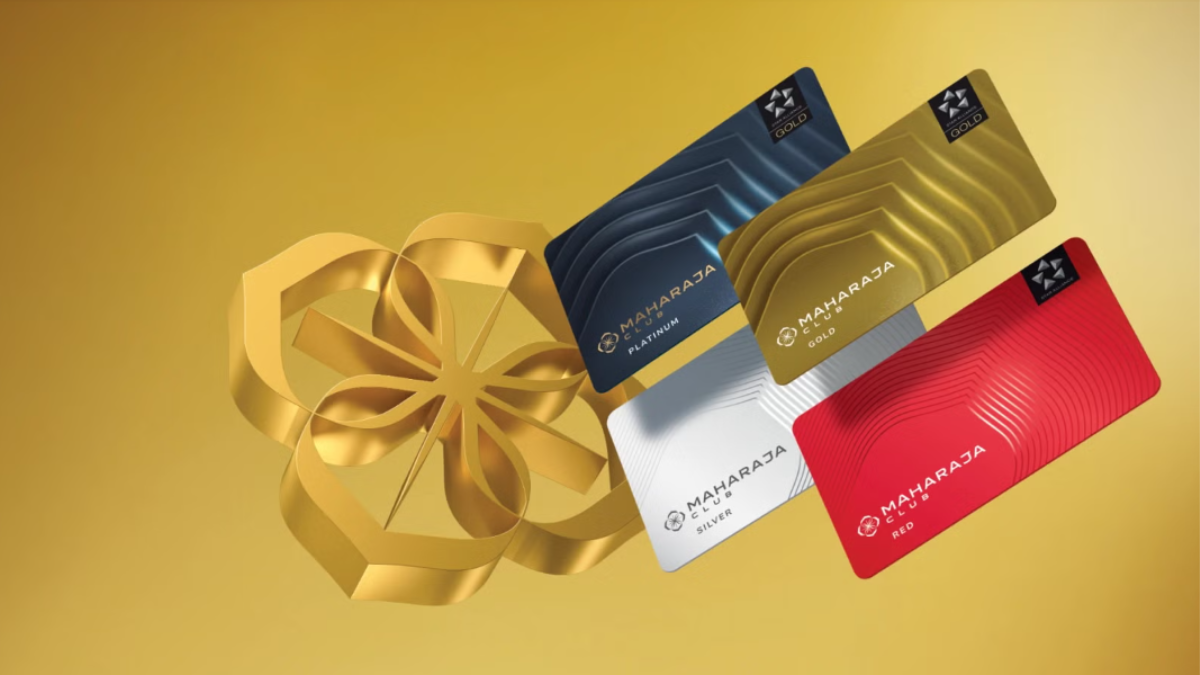 A display of the four Air India Maharaja Club membership cards: Platinum, Gold, Silver, and Red, floating against a golden background.