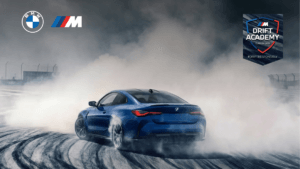 A high-performance blue BMW M4 Competition drifting on a track featuring the official BMW M Drift Academy Class of 2026 br...