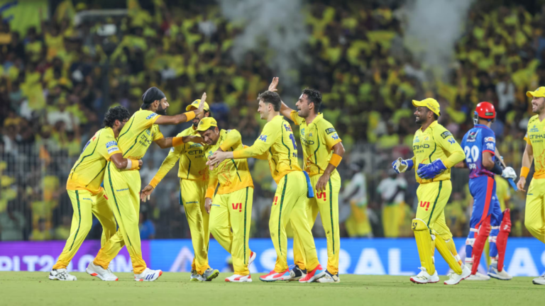 Chennai Super Kings players Jamie Overton, Gurjapneet Singh, and teammates celebrate a wicket against Delhi Capitals durin...