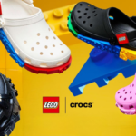A promotional group shot of the Crocs x LEGO collection featuring white, black, and pink clogs with LEGO brick-inspired mi...