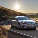 Bronze Mercedes electric C-Class driving on a winding road at sunset, showcasing the upcoming 2026 India launch