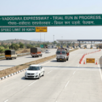 AI-generated view of the Godhra-Vadodara Expressway trial run showing the 8-lane highway, green gantry sign, and toll plaza.