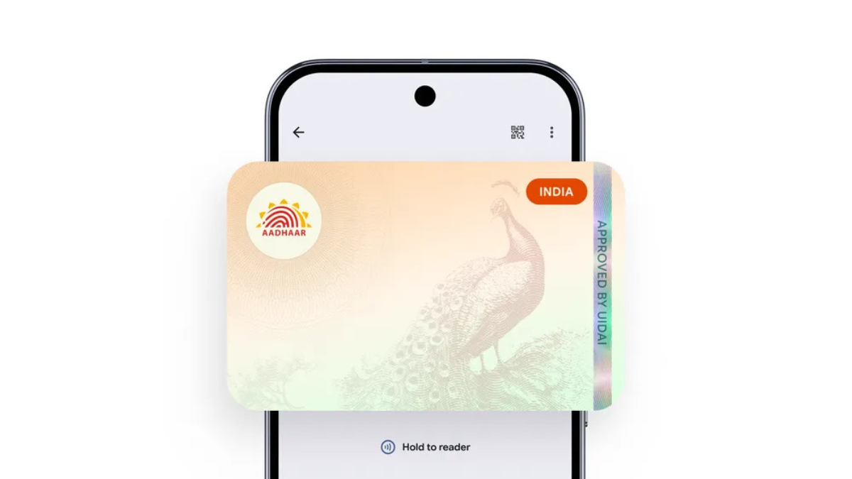 Smartphone displaying a digital Aadhaar card with a peacock design and UIDAI branding in Google Wallet for India.