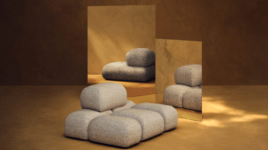 Sculptural modular Soluna lounge chair in beige textured fabric from the Kelly Wearstler x H&M HOME collection, reflected ...