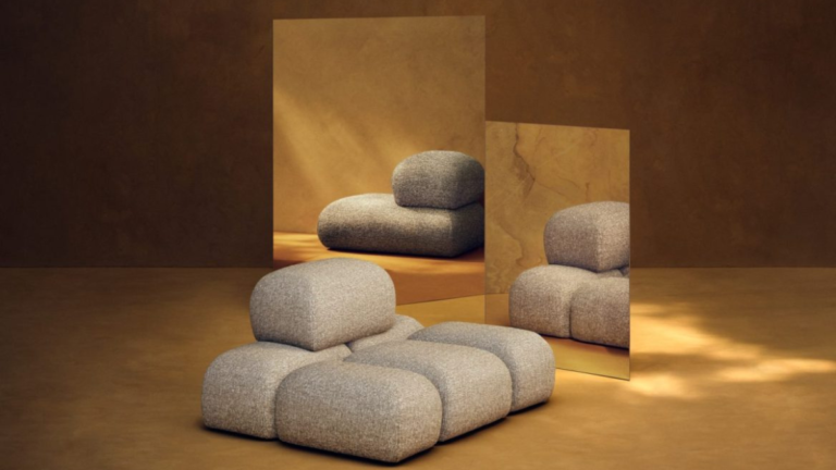 Sculptural modular Soluna lounge chair in beige textured fabric from the Kelly Wearstler x H&M HOME collection, reflected in warm-toned mirrors within a gallery setting.
